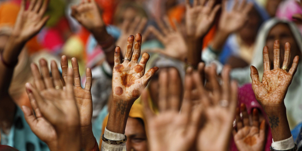 Women from rural northern India raise their hands during a protest in New Delhi, India, Thursday, Nov. 11, 2010.The protestors alleged the government was acquiring their fertile lands for different industrial projects including a nuclear plant at prices much lower than prevailing market rates. (AP Photo/Saurabh Das)